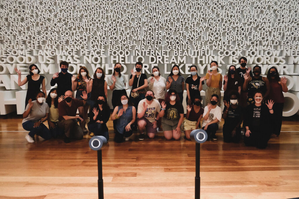 Language Science Station researchers and students in front of the Word Wall at Planet Word