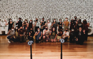 Language Science Station researchers and students in front of the Word Wall at Planet Word