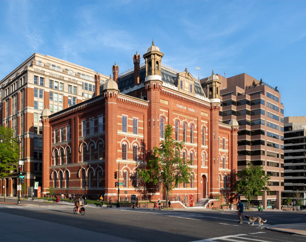 The Planet Word building. It is a historic red brick building with decorative windows, cupolas, and a mansard roof.