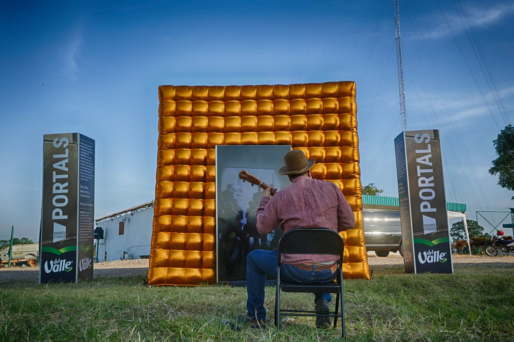 A musician at the inflatable Portal in Veracruz, Mexico, performing live for an audience at the portal in Mexico City.