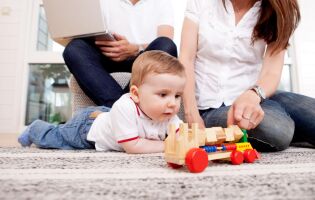 Child playing with toy on the floor