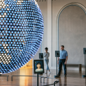 Visitors learning languages on tablets in the Spoken World gallery with a large globe to the left